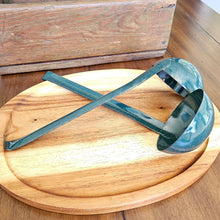 Load image into Gallery viewer, Two Green Vintage Enamelware Ladles pictured on a wooden tray. One face up, one face down, criss cross handles.

